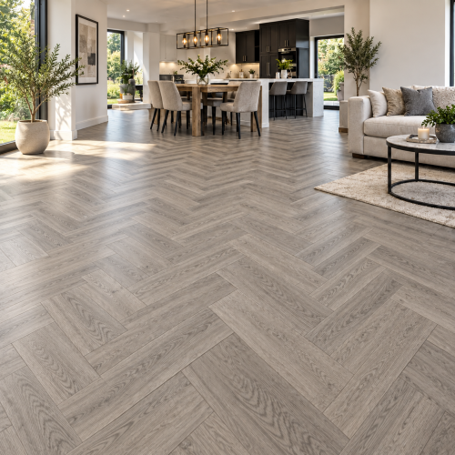 Grey oak SPC herringbone flooring in a modern living room